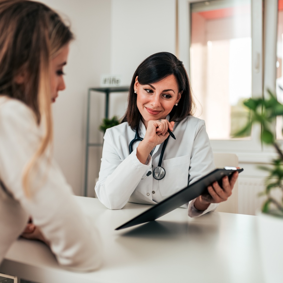 Smiling doctor consulting her patient.