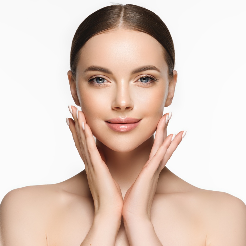 Beautiful young woman with clean fresh skin on face . Girl facial treatment . Cosmetology , beauty and spa .