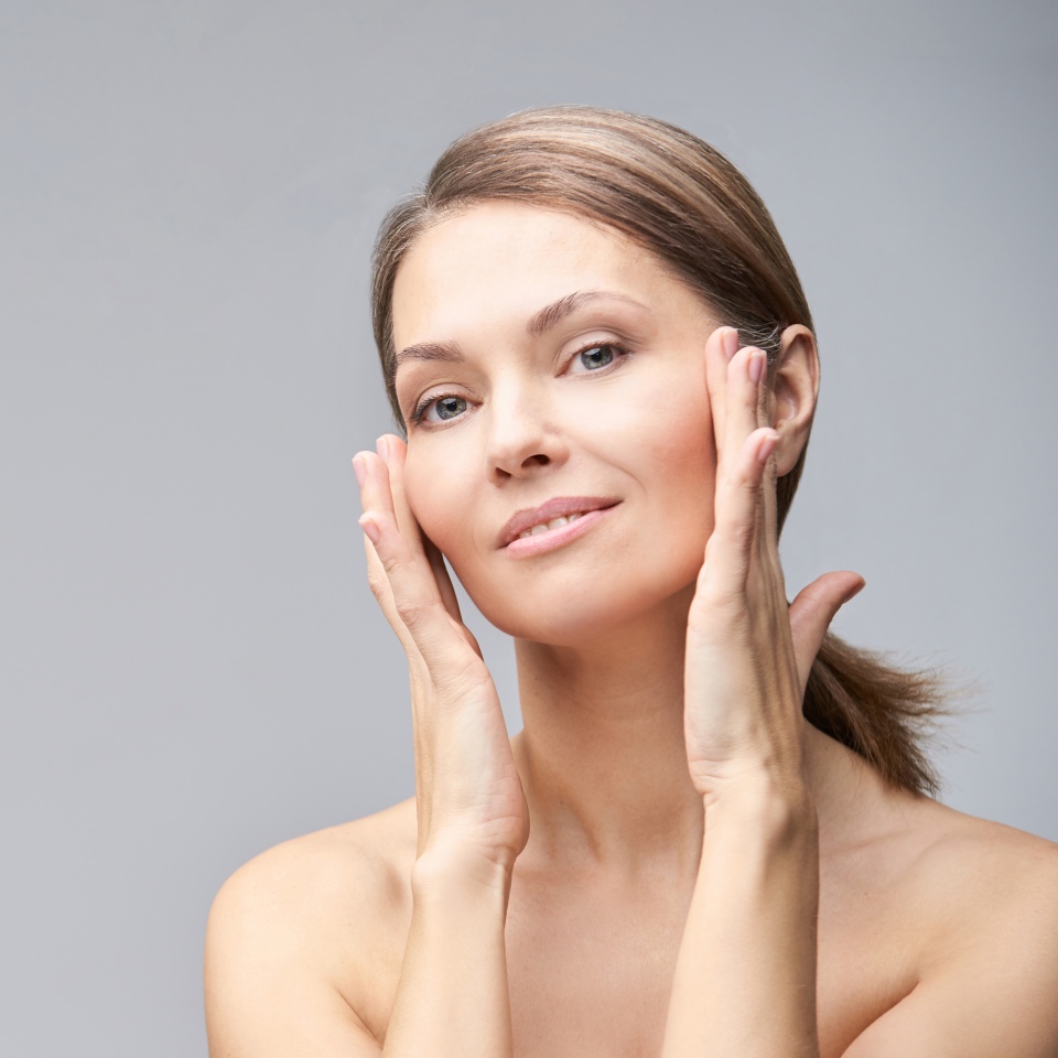 Pure skin care mature beauty portrait. Cosmetology plastic foundation. Anti wrinkle senior cream. Elegant Hands near female head. Medical treatment clinic. Woman nature makeup.