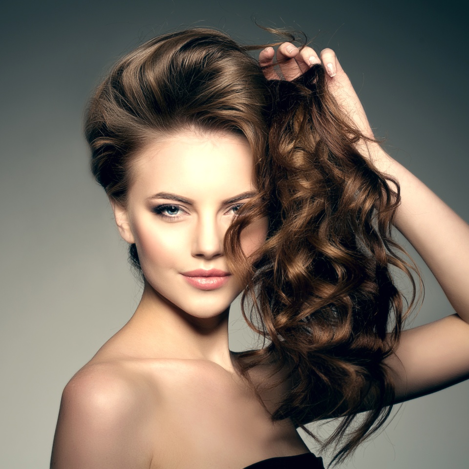 Beauty Fashion Model with long shiny hair. Waves & Curls volume Hairstyle. Hair Salon. Updo. Woman with healthy hair girl with luxurious Updo haircut. Hair loss.