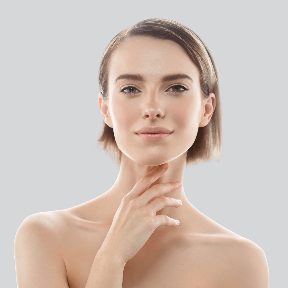 Beauty Woman face Portrait. Beautiful model Girl with Perfect Fresh Clean Skin. Blonde short hair Youth and Skin Care Concept. Isolated on a gray background