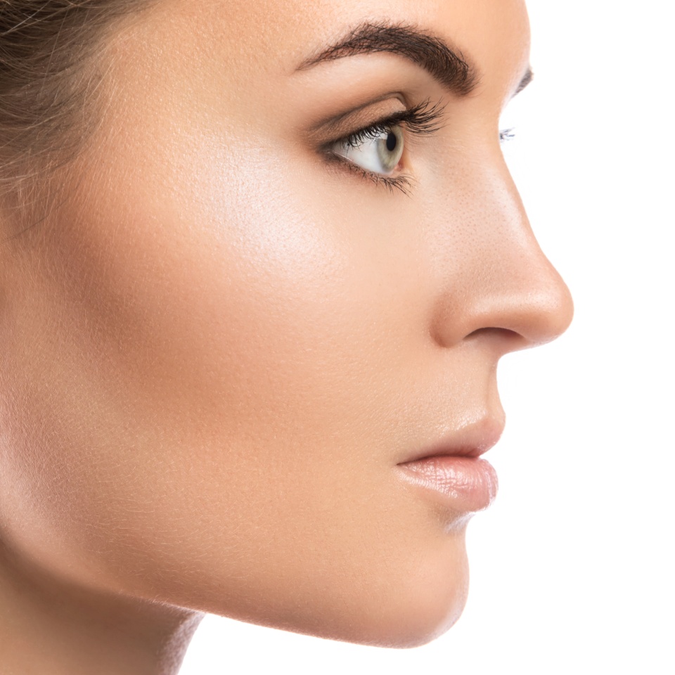 Female face in profile on white background