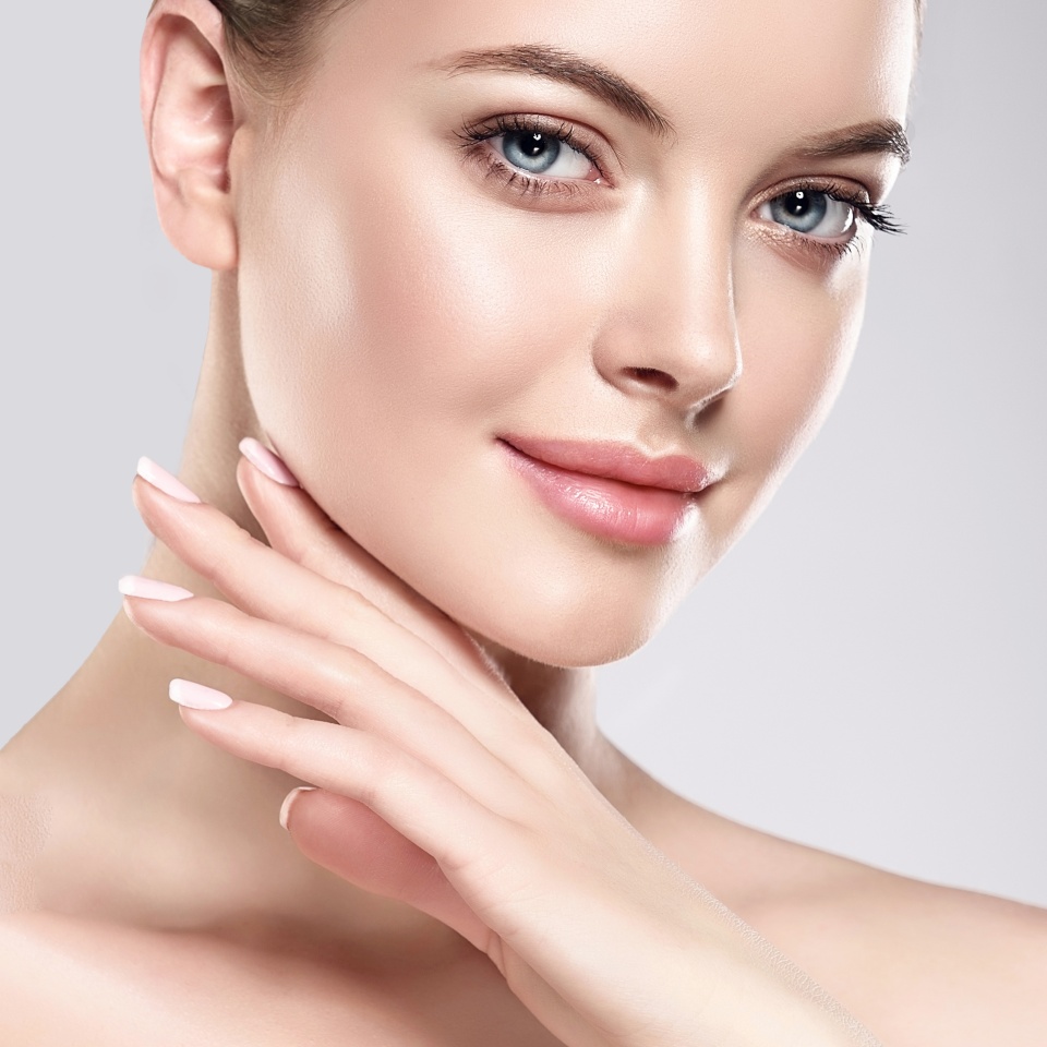 Beautiful Young Woman with Clean Fresh Skin . Facial treatment . Cosmetology , beauty and spa . Skin care